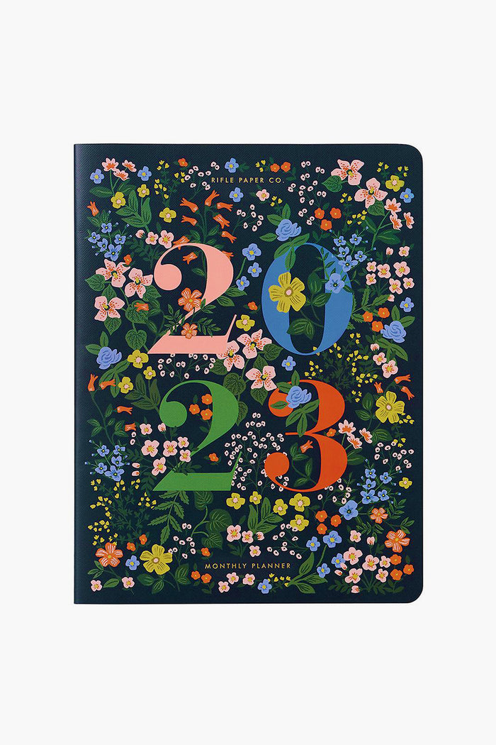A 2023 planner by Rifle Paper Co. featuring large colorful numbers and the vibrant Mayfair Floral design.
