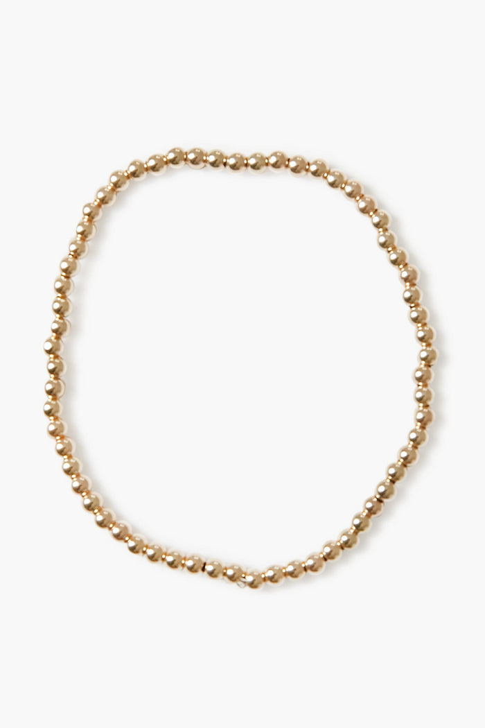 Alexa Leigh gold beaded necklace arranged in a loose circle, echoing the look of a stacking or gold ball bracelet, crafted with 14k gold plated elegance.