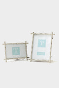 Two's Company presents two silver photo frames featuring a bamboo motif—one in a horizontal display and the other vertical—highlighting their distinctive design.