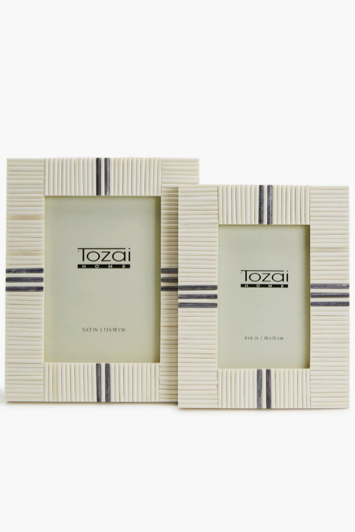 Two cream-colored Two's Company bone inlay frames, one larger than the other, feature vertical and horizontal line patterns with dark gray accent stripes and are displayed side by side.