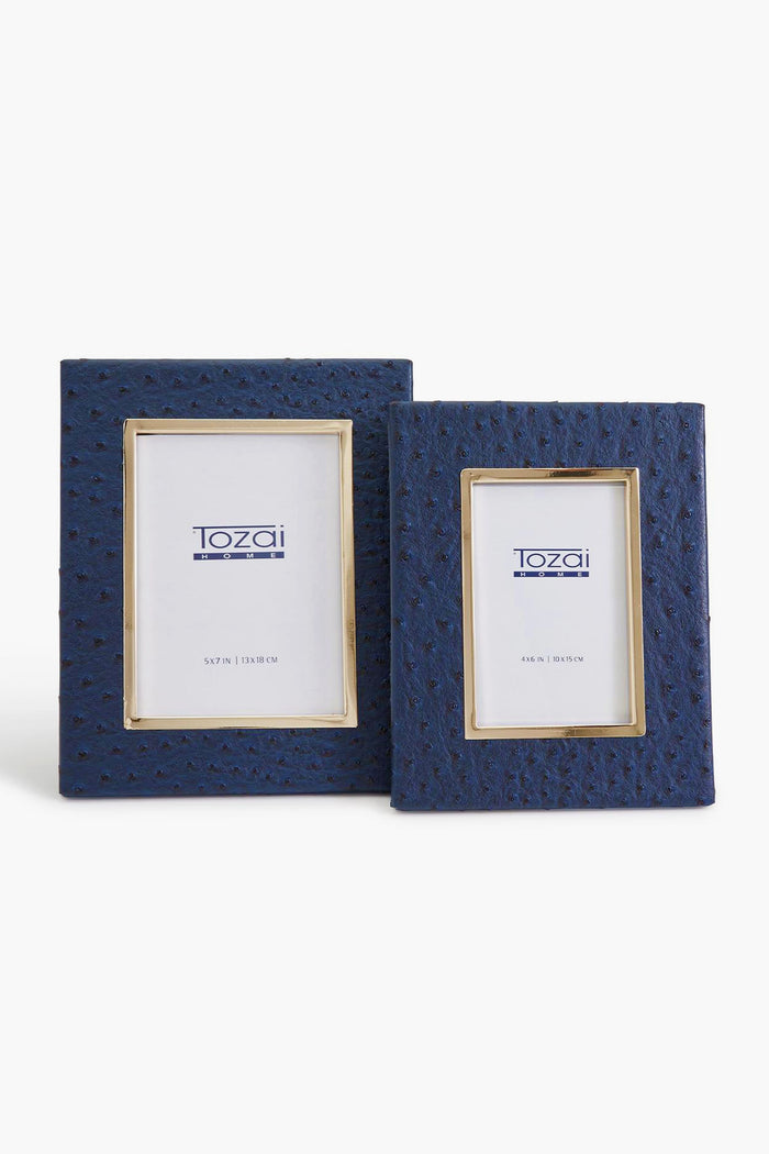 Two blue textured photo frames by Two's Company—a large and a small—are displayed side by side. Each features an ostrich pattern vegan leather finish and comes with branded placeholder paper.
