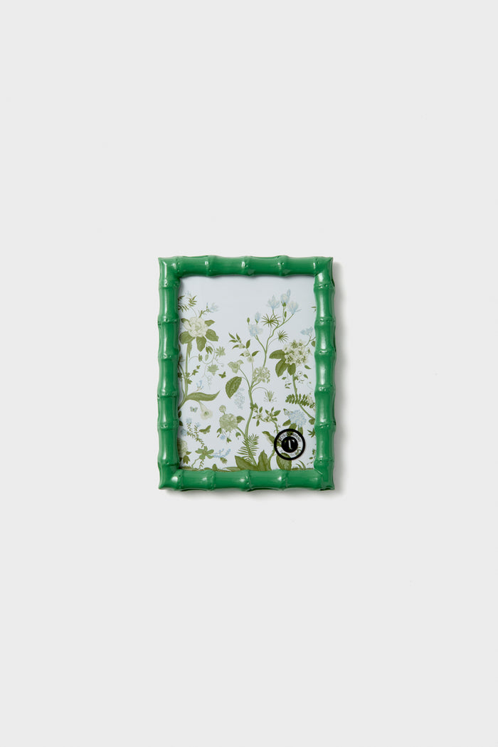 The Two's Company small rectangular chinoiserie photo frame features a green bamboo-style border showcasing a botanical illustration—an ideal accent to add charm to your home decor.