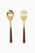 Two's Company presents elegant salad servers featuring gold-tone hardware and acacia wood. This matching set includes one spoon and one fork, designed to serve salads in style.