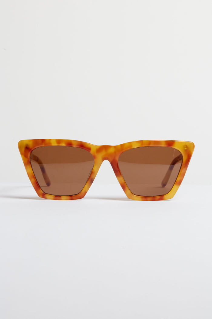 A pair of angular tortoise-frame sunglasses with brown lenses—the Amber Lisbon Sunglasses by Illesteva showcase handmade Italian craftsmanship.