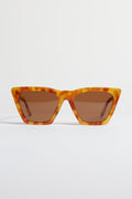 A pair of angular tortoise-frame sunglasses with brown lenses—the Amber Lisbon Sunglasses by Illesteva showcase handmade Italian craftsmanship.
