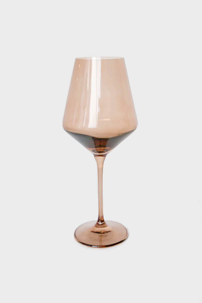 A single Estelle Colored Glass wine glass, vintage-inspired with a brown tint, wide bowl, and slender stem, expertly crafted from hand-blown colored glass.