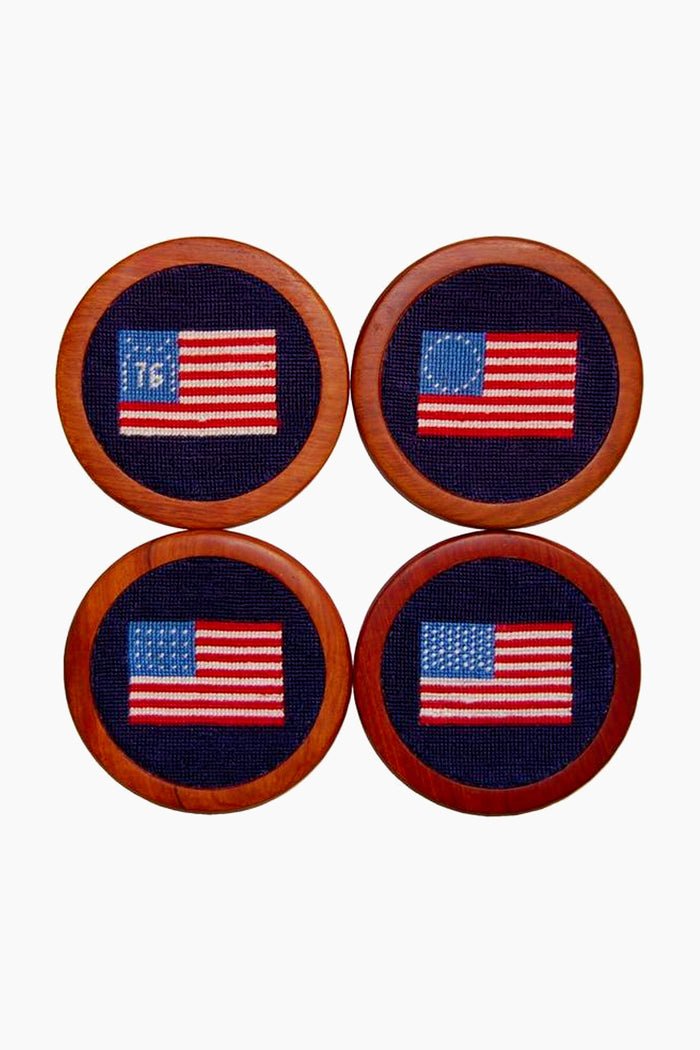 Four hand-stitched coasters by Smathers and Branson, each featuring a unique historical or modern American flag design, are displayed in a 2x2 grid.