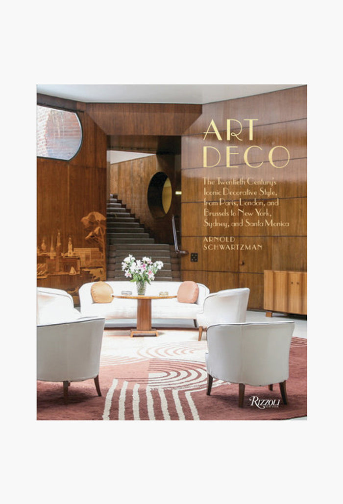 Rizzoli’s book "Art Deco" by Arnold Schwartzman features a cover with a modern interior—white chairs, spiral staircase, and round table with flowers—that reflects classic decorative styles.