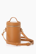 Paravel tan cylindrical full-grain leather crossbody bag with a top handle, gold zipper, and adjustable shoulder strap. This lightweight bag blends stylish design with everyday practicality.