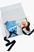 Tuckernuck Tots gift box with a blue shark-themed hooded towel and two bath squirters, finished with black ribbon—perfect for toddler gifts.