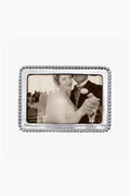 A black and white photo of a bride and groom dancing, with the groom’s face partially out of view, displayed in a Mariposa beaded recycled aluminum frame.