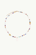 Beaded Multi Pearl Drop Necklace by Petit Moments features colorful beads, clear rounds, a teardrop pendant center, and is finished with a gold clasp and adjustable chain. From a woman-owned brand.