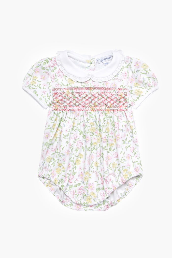 Nella Pima baby romper made from soft Peruvian Pima cotton, with short sleeves, white Peter Pan collar, floral print, and smocked chest—an adorable smocked bubble onesie.