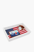 A Smathers and Branson American flag valet tray holds their hand-stitched needlepoint leather sailboat wallet and a brown leather band wristwatch—an ideal housewarming gift.