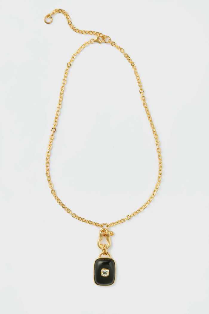 Lizzie Fortunato gold chain necklace with a rectangular black agate pendant and central clear gemstone, inspired by the Ancient City Necklace collection.