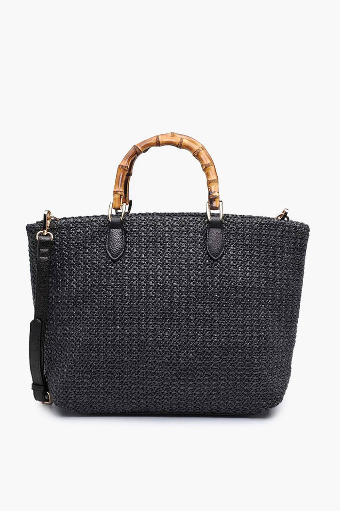 Moda Luxe black woven bamboo handle handbag with a detachable shoulder strap, featuring chic bamboo-style handles and a vegan straw tote design.