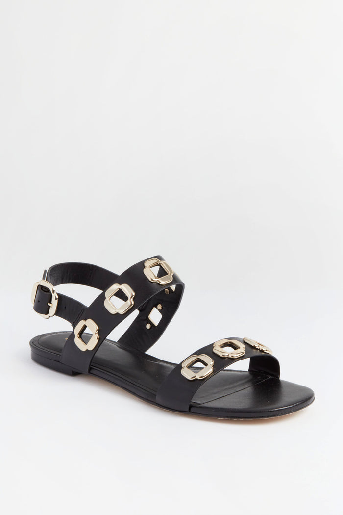 Larroude black leather Milan Sandals feature gold buckle accents, chunky chain strap details, and an ankle strap with buckle closure.