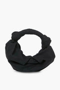 The Simon Miller Black Lopsy Bag is a chic, black fabric knot handle purse with a soft, rounded shape—perfect for any occasion.