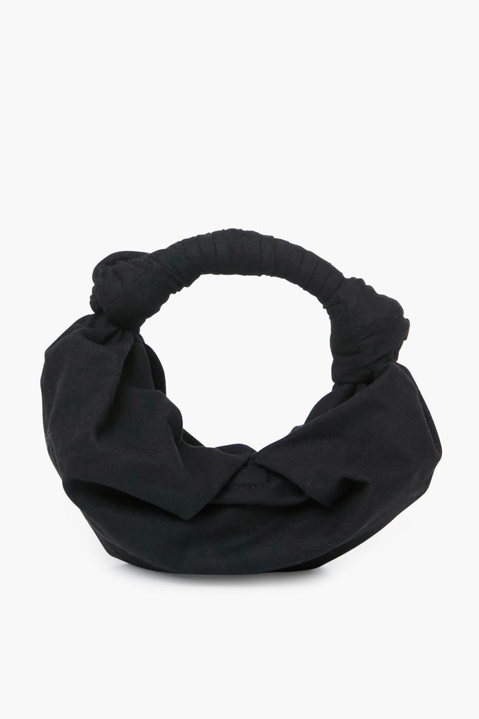 The Simon Miller Black Lopsy Bag is a chic, black fabric knot handle purse with a soft, rounded shape—perfect for any occasion.