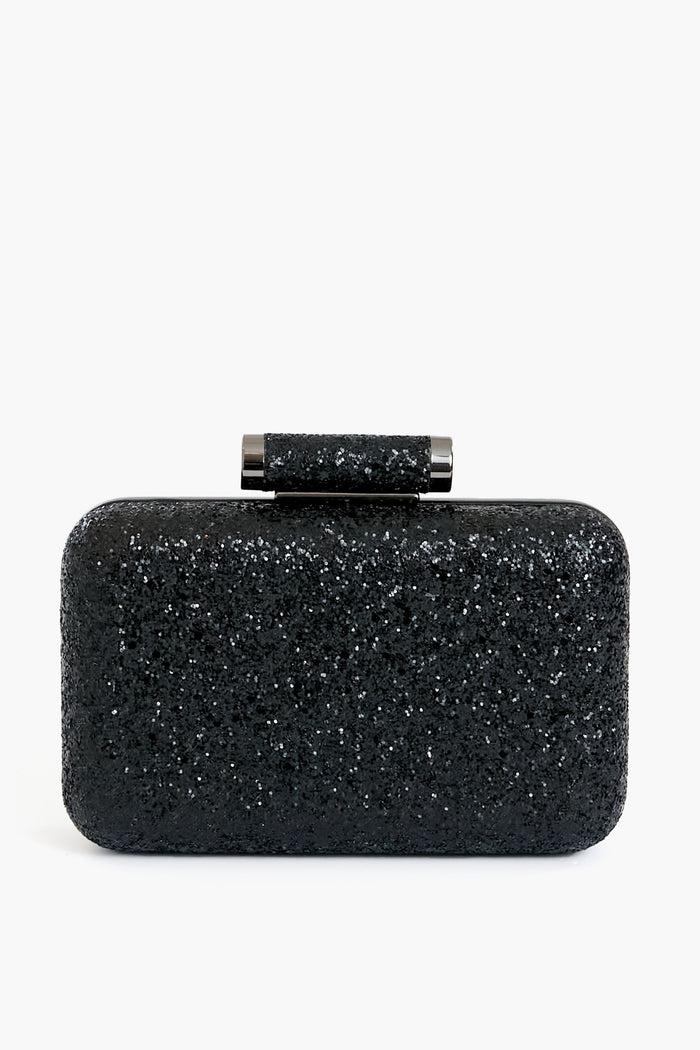 The Olga Berg rectangular black glitter clutch evening bag features a matching cylindrical clasp and is crafted from vegan leather.
