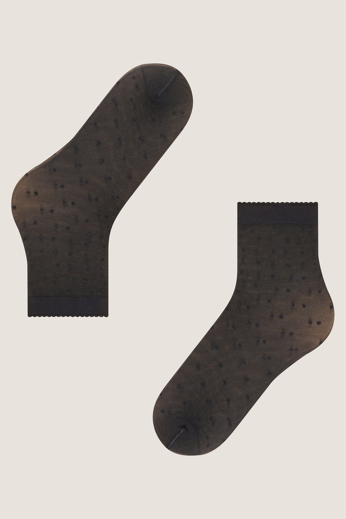 Black Sheer Polka Dot Socks with scalloped cuffs and tiny dot pattern, offering an effortless, fun, and high-end look for any outfit.