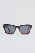 A pair of DIFF Eyewear rectangular tortoiseshell sunglasses with dark lenses rests on a plain white surface.