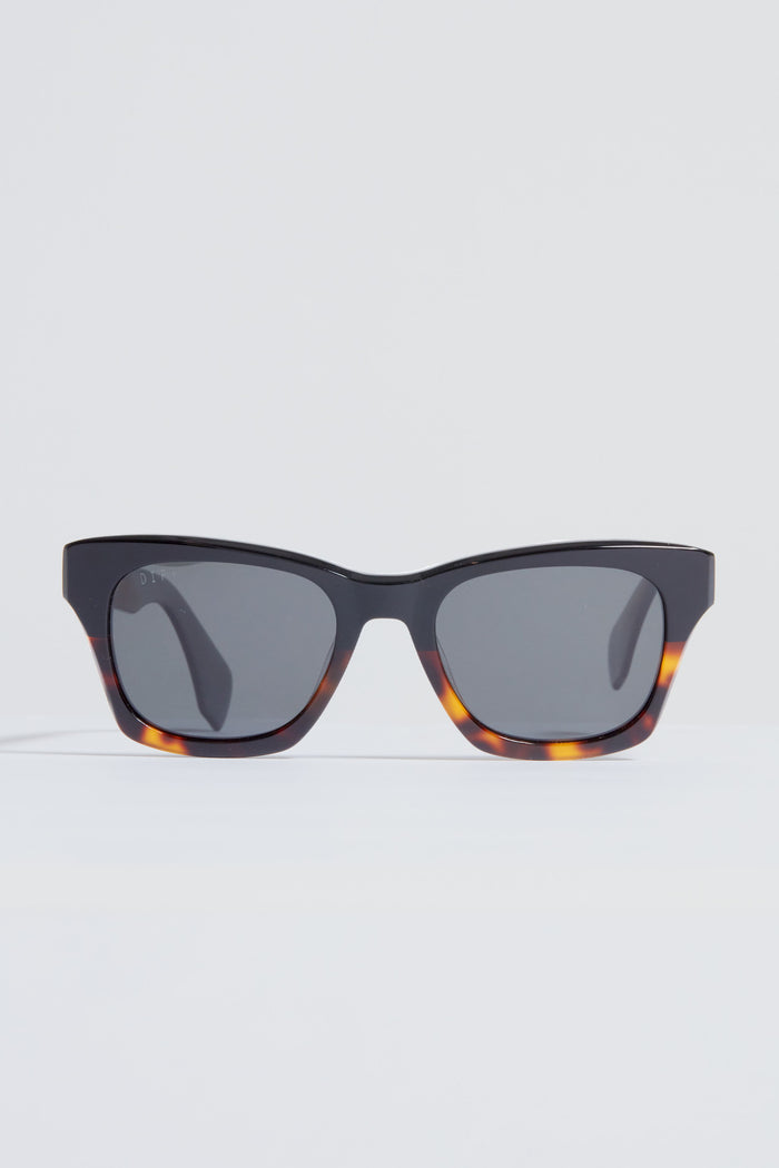 A pair of DIFF Eyewear rectangular tortoiseshell sunglasses with dark lenses rests on a plain white surface.