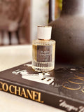 Black Truffle & Patchouli Eau de Parfum by LU Fragrances - 50ml ribbed glass bottle on a Coco Chanel coffee table book, Tom Ford Black Orchid type