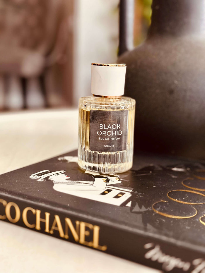 Black Truffle & Patchouli Eau de Parfum by LU Fragrances - 50ml ribbed glass bottle on a Coco Chanel coffee table book, Tom Ford Black Orchid type