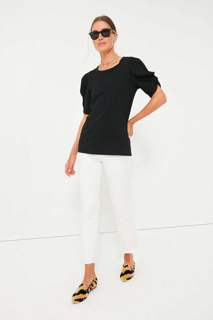 Woman models the classic Black Vesty Puff Short Sleeve Crewneck, featuring effortless puffed sleeves with knot ties, styled with chic, high-end accessories for a fun, confident look.