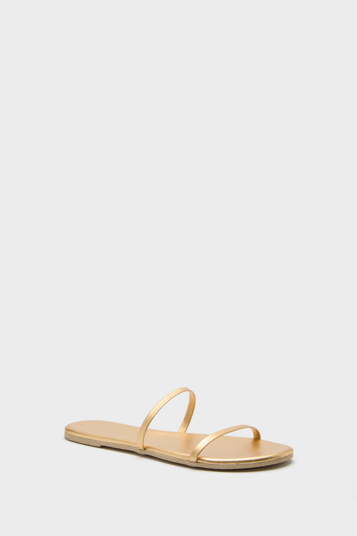 TKEES gold flat sandals feature two thin straps over the foot, making them the perfect metallic sandals for any occasion.
