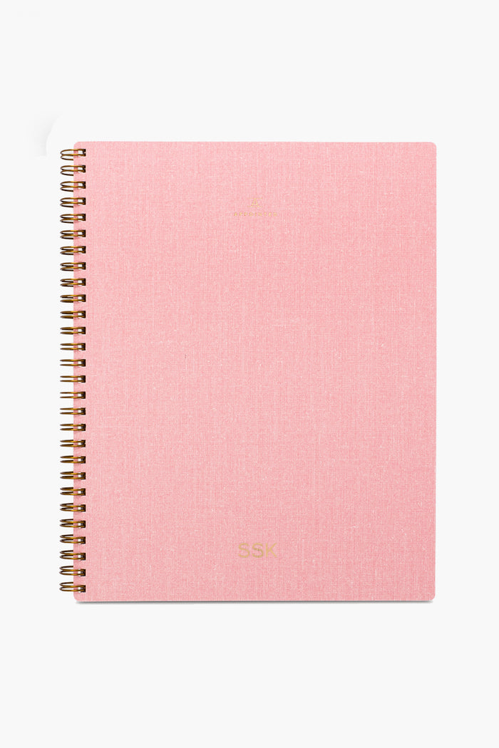 The APPOINTED Blossom Pink Lined Notebook features a textured book-cloth cover, gold lettering, spiral binding, and is crafted from recycled paper.