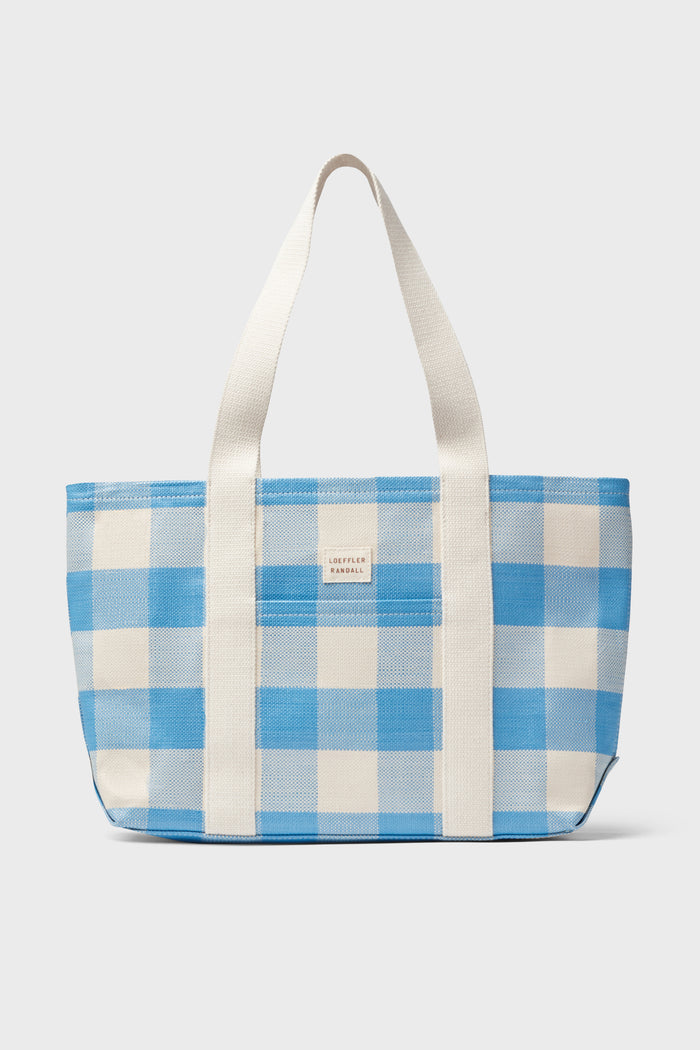 A Loeffler Randall tote bag in blue and cream gingham with white handles and a small front label is shown.