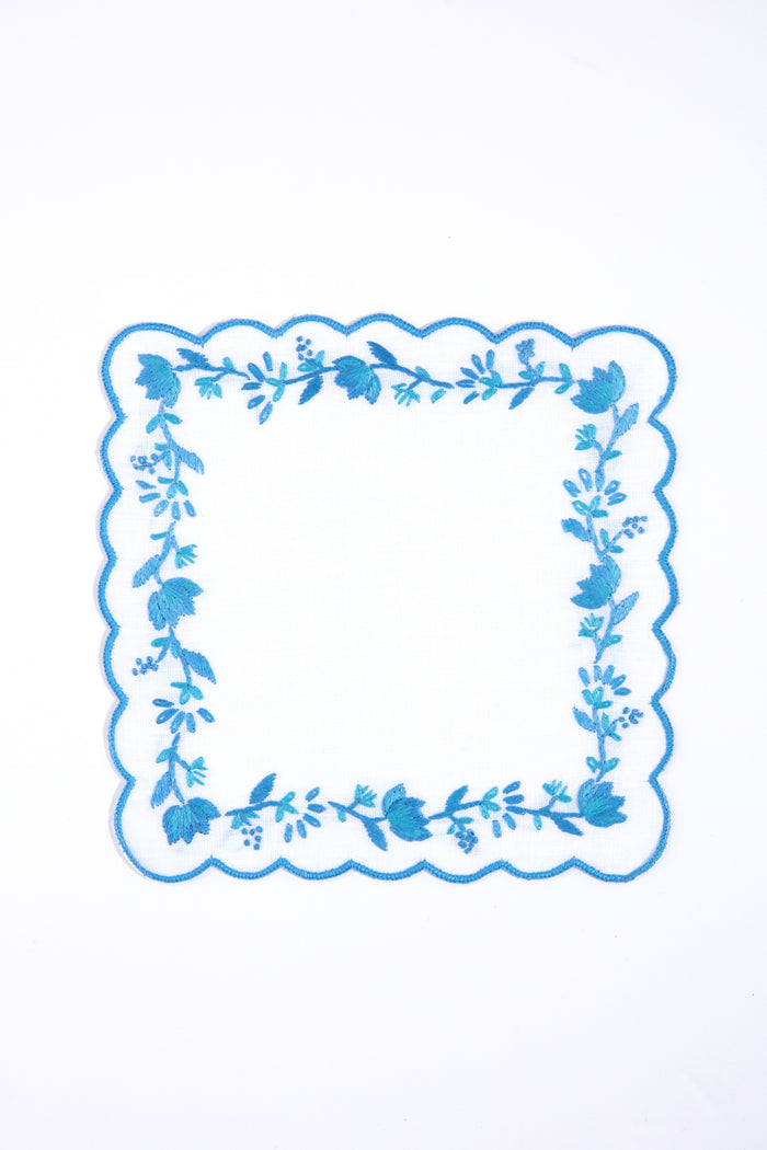 Tuckernuck Home’s square white handkerchief features blue scalloped edges and floral embroidery, making it perfect as a Blue and White Floral Cocktail Napkin for decorating your next cocktail party.