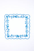 Tuckernuck Home’s square white handkerchief features blue scalloped edges and floral embroidery, making it perfect as a Blue and White Floral Cocktail Napkin for decorating your next cocktail party.