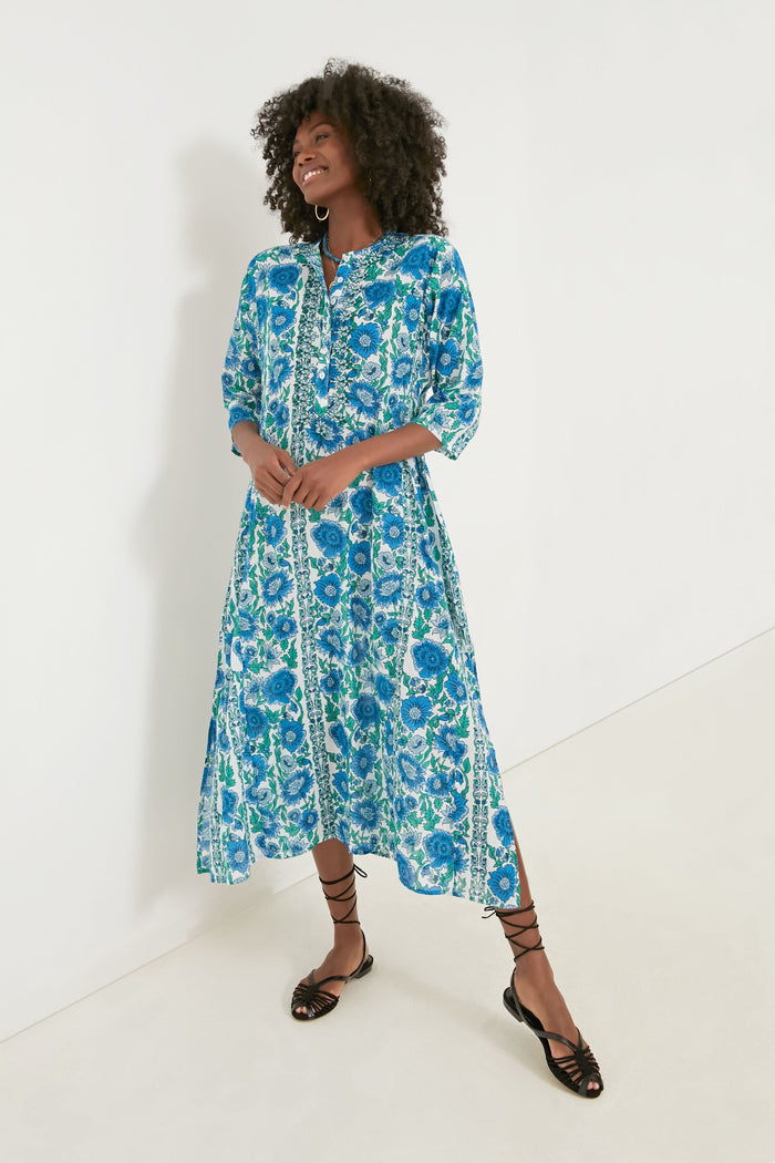 A woman wears a Ro's Garden Blue Dijon Classic Long Kurta, styled as a floral midi dress with three-quarter sleeves and black lace-up sandals—perfect luxury travel wear.