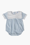 The Nella Pima Blue Gingham Bubble is a light blue baby romper made from luxurious Peruvian Pima cotton, featuring short sleeves, a white collar, and button-back closure—perfect for your little one.