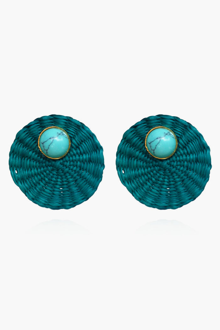 Ana Carolina Valencia round teal woven turquoise stud earrings feature a central turquoise stone framed by a thin gold-plated bronze rim—a stunning piece of handmade jewelry.