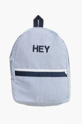 A blue and white seersucker striped Caton's Wharf backpack featuring a front zipper pocket and "HEY" embroidered in black on the front.
