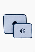 Two rectangular, blue-and-white striped fabric pouches with dark blue trim and a circular KRC monogram from Caton's Wharf—perfect as travel pouches or a thoughtful bridesmaids gift in the Blue Seersucker Travel Set.
