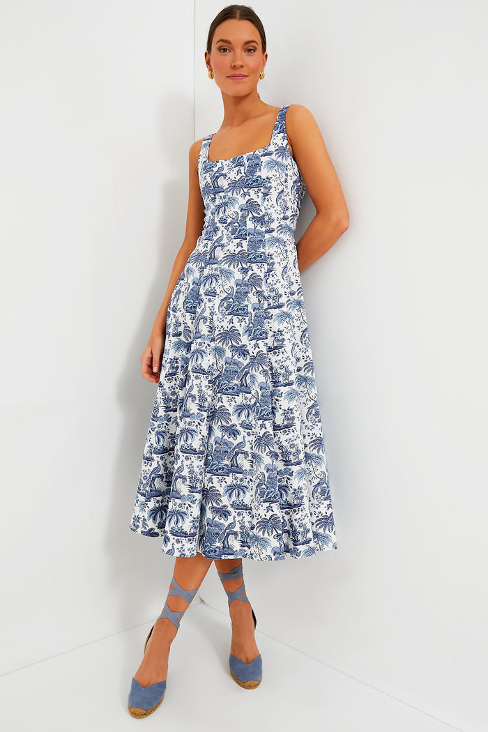 A woman wears a STAUD blue and white printed sleeveless corset-style midi dress with a square neckline, paired with blue ankle-tie espadrille shoes.
