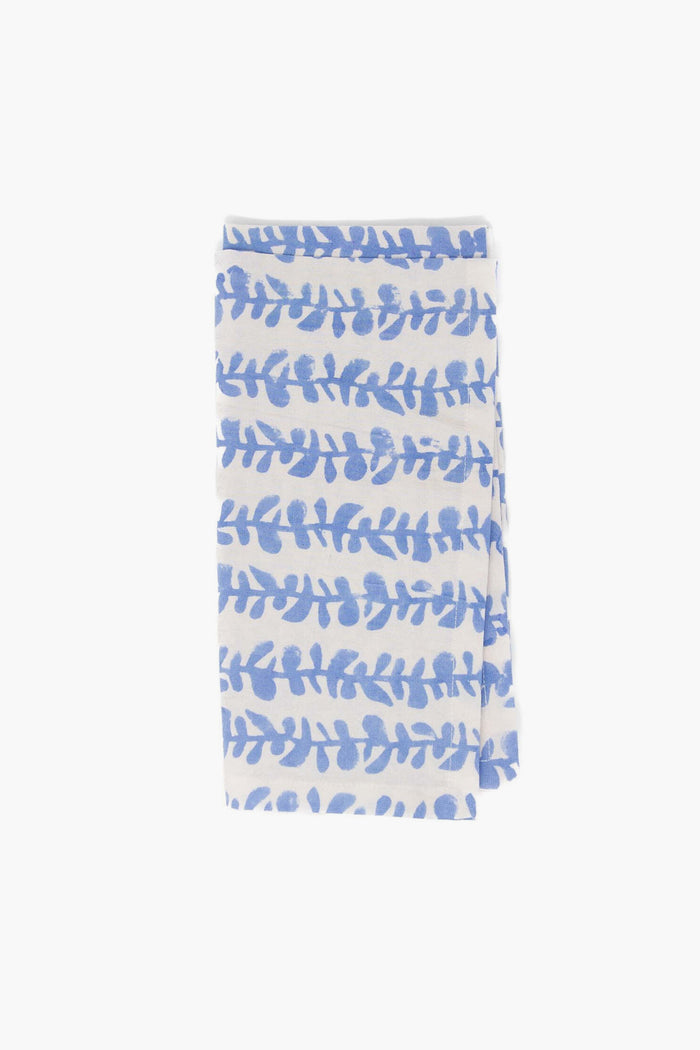 A folded white Modafleur cloth with blue leaf-patterned horizontal stripes, ideal as blue vine napkins or tabletop linens for any dining setting.