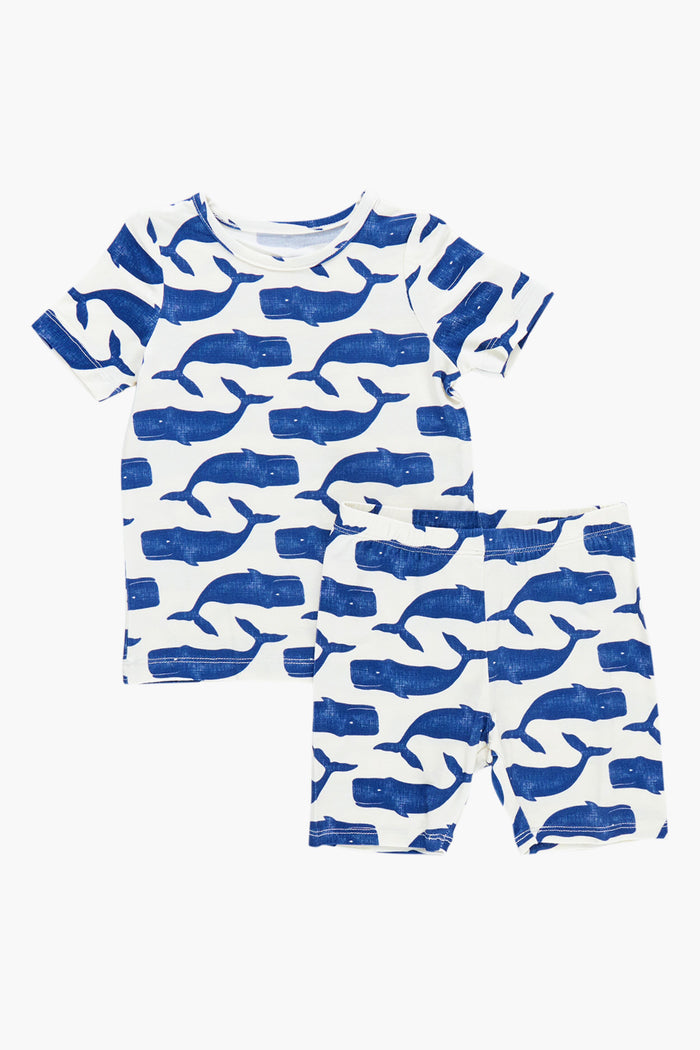 Stay cozy with Pink Chicken’s matching short-sleeve shirt and shorts pajama set, featuring a charming blue whale pattern—perfect for bedtime comfort.