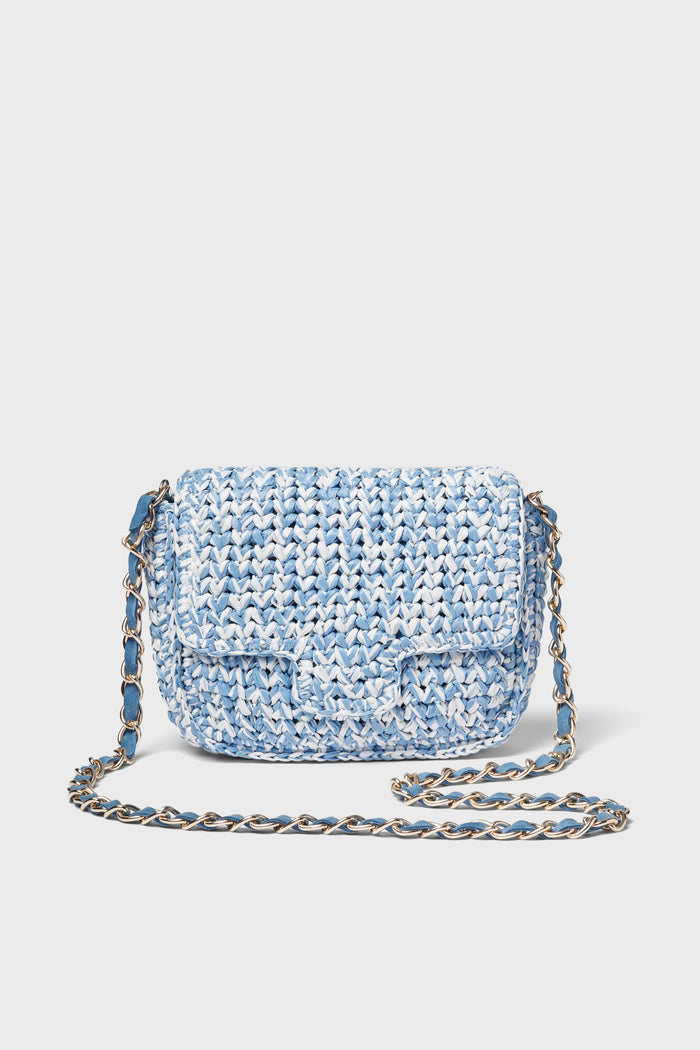 A small Italian crossbody bag by Caterina Bertini in blue and white, featuring a woven design, flap closure, and chain strap.