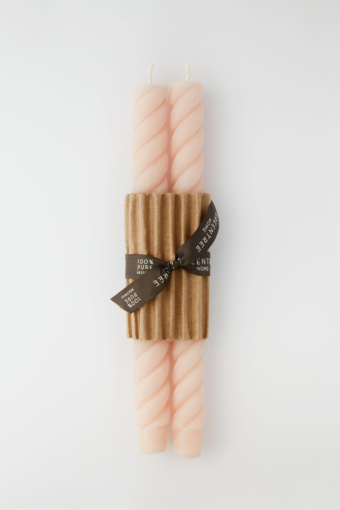 Greentree Home’s elegant set includes two pale pink hand-poured beeswax tapers, bundled with a corrugated cardboard sleeve and brown ribbon—a thoughtful housewarming gift.