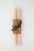 Greentree Home’s elegant set includes two pale pink hand-poured beeswax tapers, bundled with a corrugated cardboard sleeve and brown ribbon—a thoughtful housewarming gift.