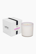 A LAFCO New York Blush Rose Signature Candle in handblown white glass is displayed beside its white box with a black stripe and product label, delivering an elegant home fragrance experience.