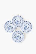 Four round white botanical plates by One Hundred 80 Degrees feature blue floral patterns and are arranged in a slightly overlapping cluster. Made from melamine, these plates combine style with dishwasher-safe convenience.