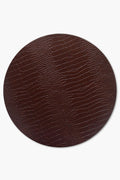 Chefanie's oval brown placemat features a textured, reptile-skin-inspired pattern—ideal for adding elegance and sophistication to your neutral tablescape.