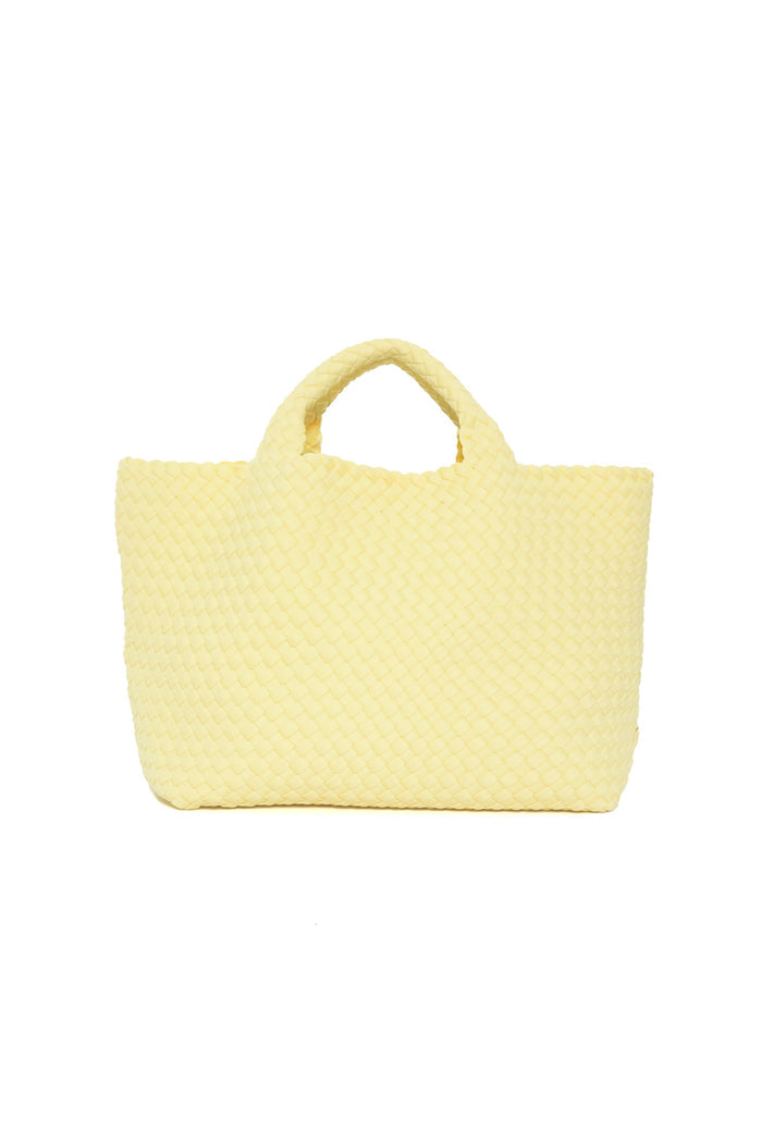 A yellow woven tote bag with two handles by Naghedi, inspired by their signature style and the popular St Barths Medium Tote.